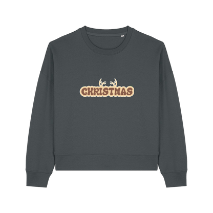 grey christmas sweater with the slogan 'christmas' and antlers poking out of the top