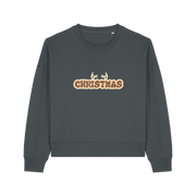 grey christmas sweater with the slogan 'christmas' and antlers poking out of the top
