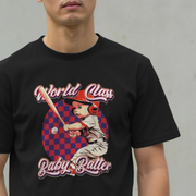 Person wearing a black humorous t-shirt with a cool graphic of a baby playing baseball and slogan 'World Class Baby Batter' on a plain background.