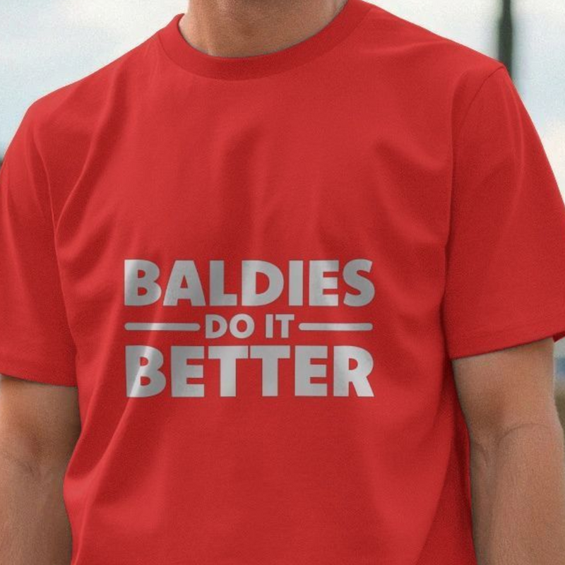 Red funny slogan t-shirt with the cheeky slogan 'BALDIES DO IT BETTER' worn by a person.