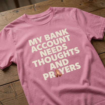 Pink My Bank Account Needs Thoughts and Prayers t-shirt on wood, funny relatable slogan ladies tee