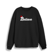 black christmas sweate with the slogan 'believe' and a santa hat on top of the b