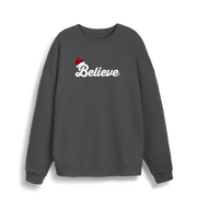grey christmas sweate with the slogan 'believe' and a santa hat on top of the b