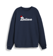navy christmas sweate with the slogan 'believe' and a santa hat on top of the b