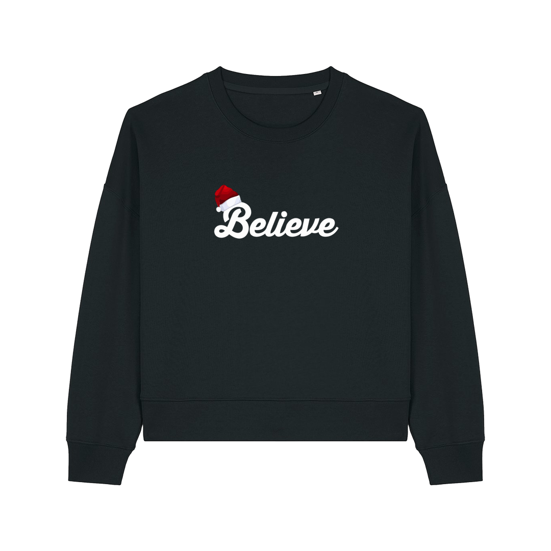 black christmas sweater with the slogan 'believe' and a santa hat on top of the b