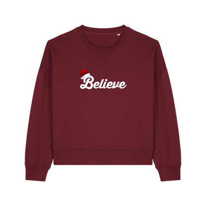 burgundy christmas sweater with the slogan 'believe' and a santa hat on top of the b