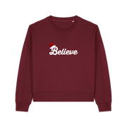 burgundy christmas sweater with the slogan 'believe' and a santa hat on top of the b