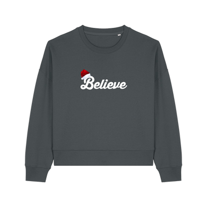 grey christmas sweater with the slogan 'believe' and a santa hat on top of the b