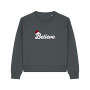 grey christmas sweater with the slogan 'believe' and a santa hat on top of the b