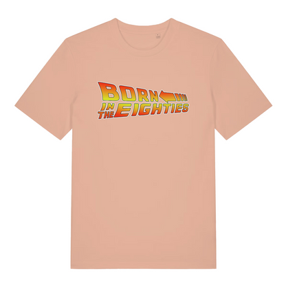 Peach women's Born in the Eighties T-shirt flat lay showing dynamic 80s movie lettering with arrow design