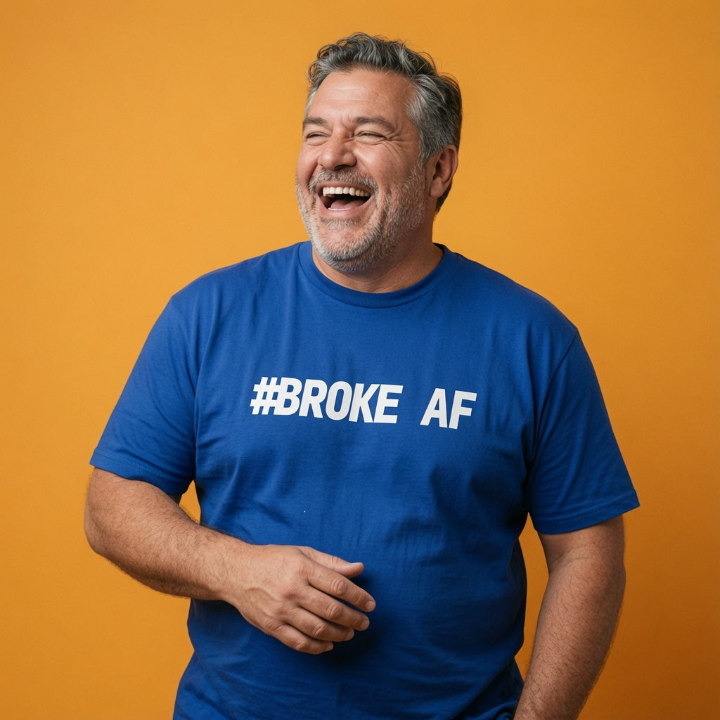 Man laughing while wearing a blue #BROKE AF t-shirt, humorous mens matching slogan design full of pure attitude