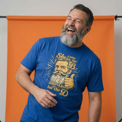 Man laughing with one hand near his chest in a blue She Came for the B and Stayed for the D t-shirt, funny Fathers Day gift design full of pure attitude