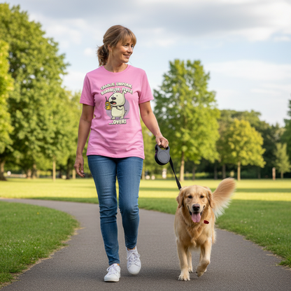 woman walking her dog in the park wearing a pink graphic t-shirt with a dog design