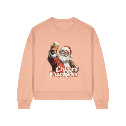 peach christmas sweater with a graphic of santa raising a pint and the slogan 'cheers fuckers'