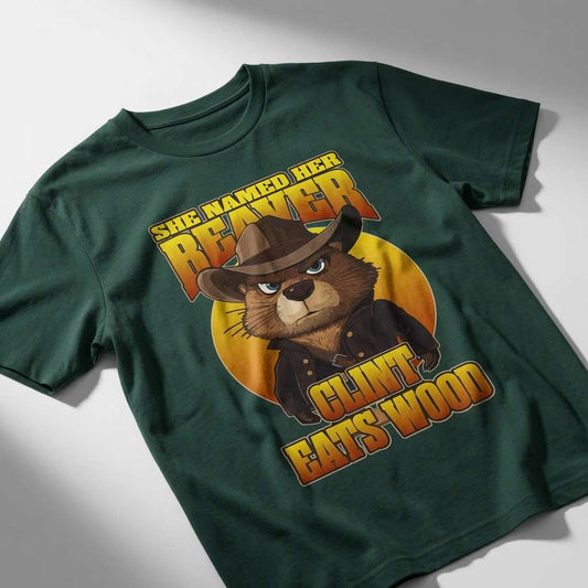 Green She Named Her Beaver Clint Eats Wood t-shirt on surface, funny rude mens beaver graphic tee