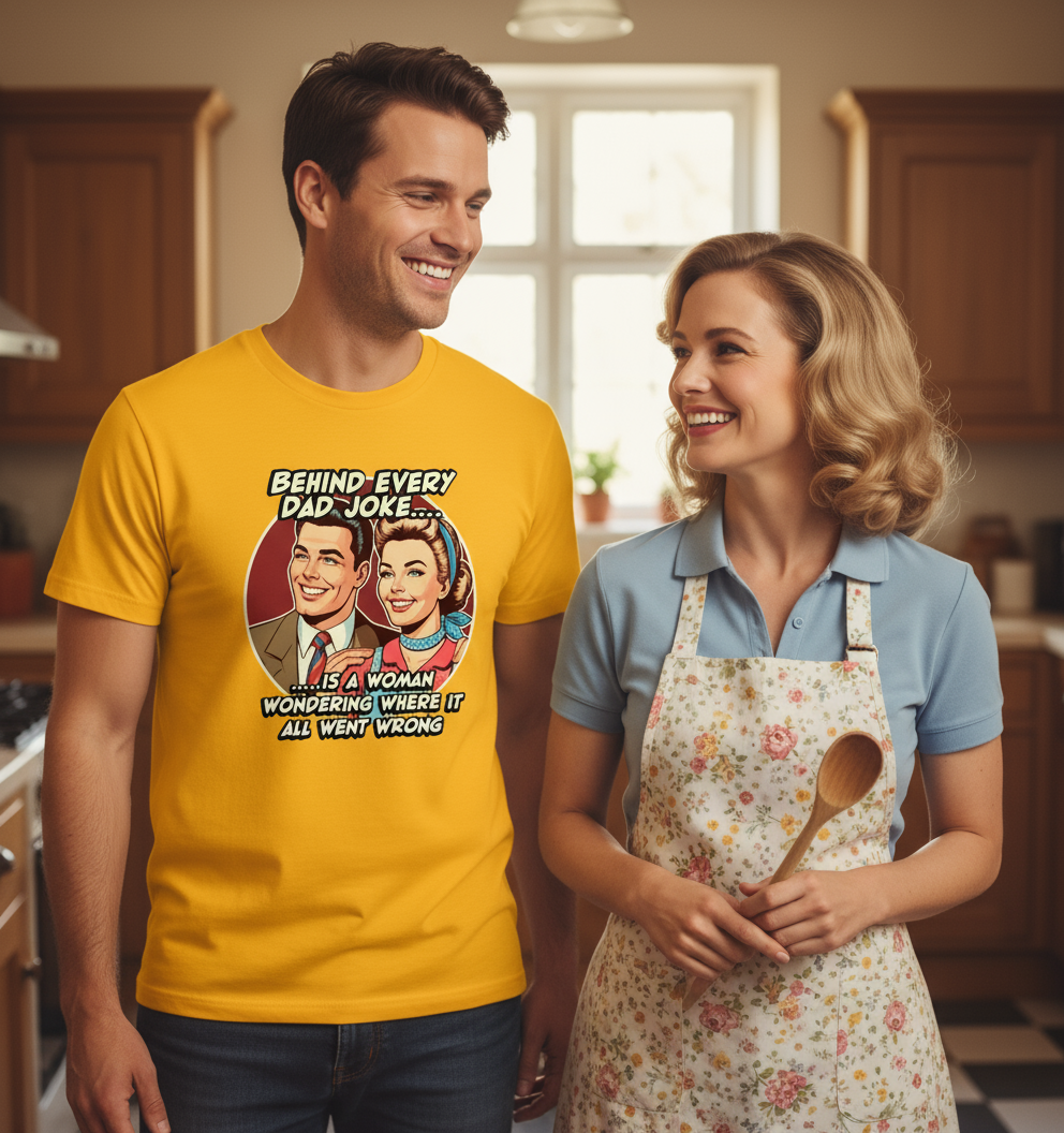 Man wearing a yellow t-shirt with a graphic and text, standing next to a woman in a kitchen.