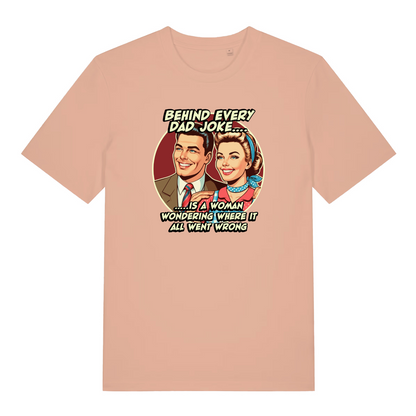 peach women's funny t-shirt with the graphic of a man an woman and the slogan 'behind every dad joke is a woman wondering where it all went wrong'