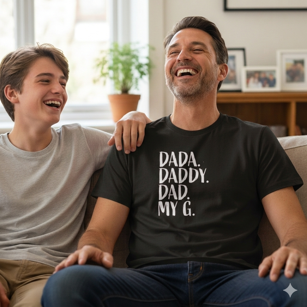 Two people sitting on a couch with one wearing a black t-shirt with text.