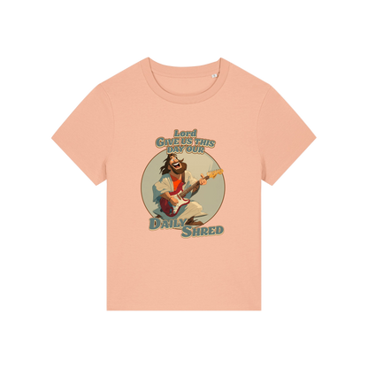 peach funny jesus t-shirt with the graphic of jesus playing a guitar and the slogan 'lord give us this day our daily shred'