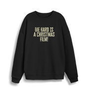 black christmas jumper with the slogan 'die hard is a christmas film'