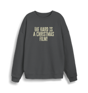 grey christmas jumper with the slogan 'die hard is a christmas film'