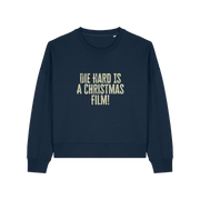 navy christmas jumper with the slogan 'die hard is a christmas film'