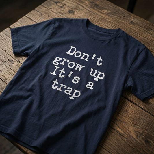Navy Don’t Grow Up It’s a Trap t-shirt on wood, funny witty age-related slogan