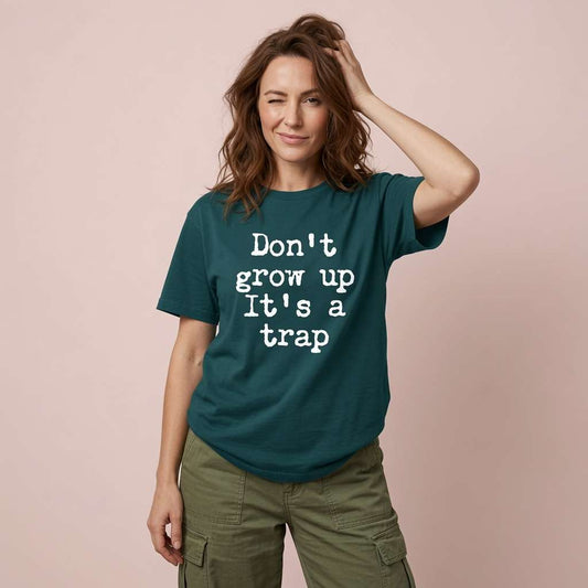 Woman winking with hand in hair in stargazer Don’t Grow Up It’s a Trap t-shirt, fun hilarious age slogan