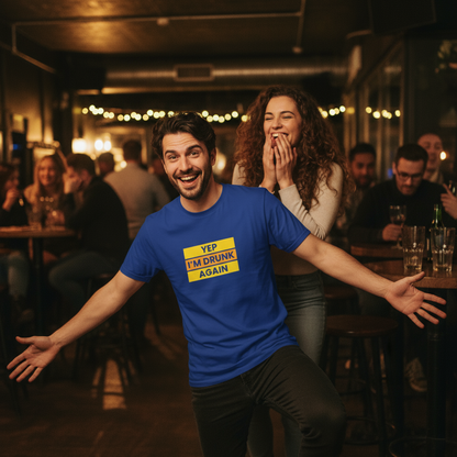 Man wearing a blue t-shirt with text in a bar setting