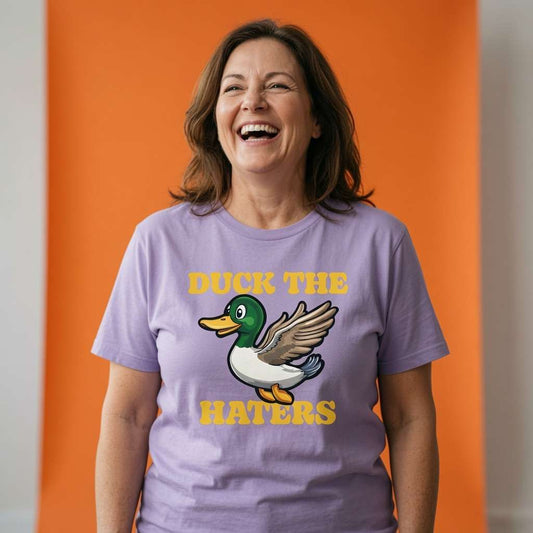 Woman laughing with head tilted back while wearing a lavender Duck The Haters t-shirt, funny ladies duck pun graphic design full of pure attitude
