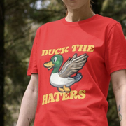 Person wearing a red funny t-shirt with a duck graphic and the slogan 