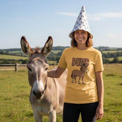 Woman wearing a yellow t-shirt with a donkey graphic and the word 'Dumb', standing next to a donkey in a field.