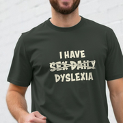 Person wearing a black slogan t-shirt with humorous text design on a plain background