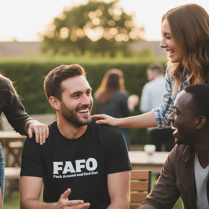 Man wearing a black t-shirt with 'FAFO' text, sitting outdoors with friends.