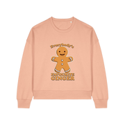 peach christmas sweater with the graphic of a gingerbread man and the slogan 'everybodys favourite ginger'