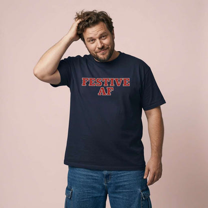 Man smiling with hand in hair in navy Festive AF tee, funny festive wit christmas