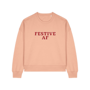 peach womens christmas sweater with the slogan 'festive af'