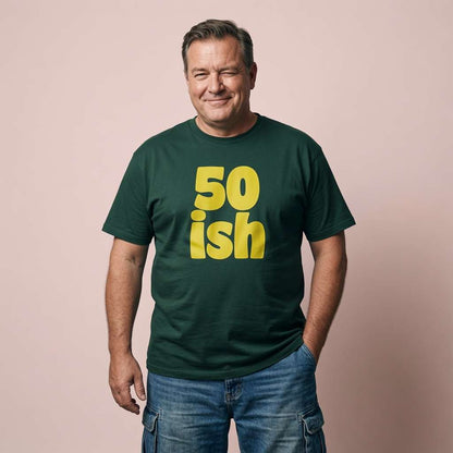 Man winking with hand in pocket in green 50 ish t-shirt, mens witty 50 year slogan