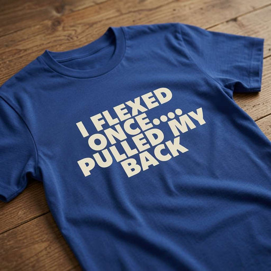 Blue I Flexed Once Pulled My Back t-shirt on wood, mens funny sarcastic slogan