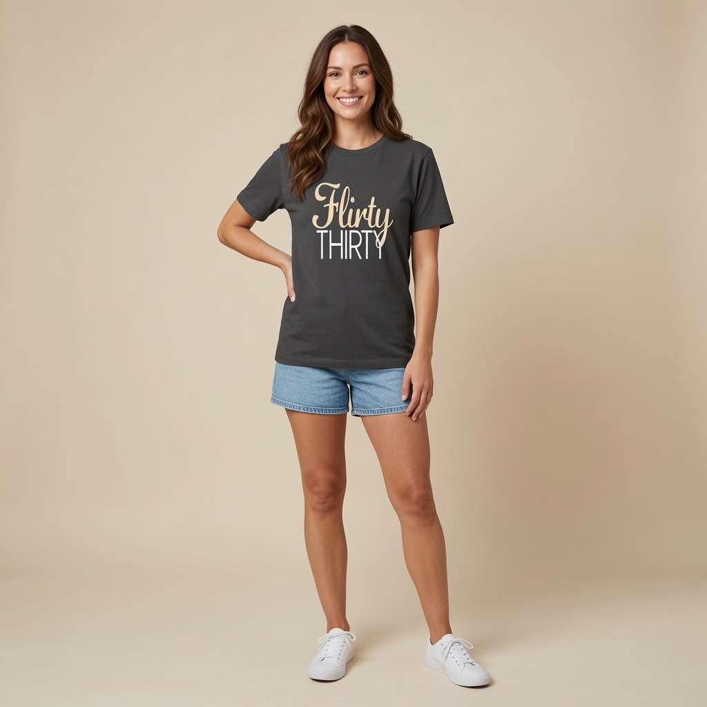 Smiling woman standing with hand on hip in black Flirty Thirty tee, fun ladies 30 slogan