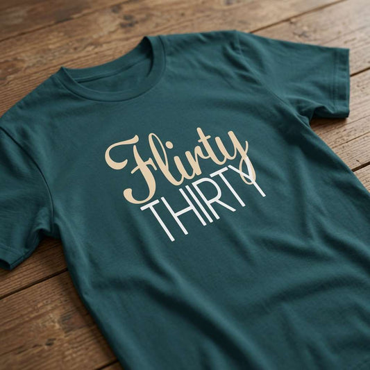Stargazer Flirty Thirty t-shirt on wood with script and block text, age related ladies slogan