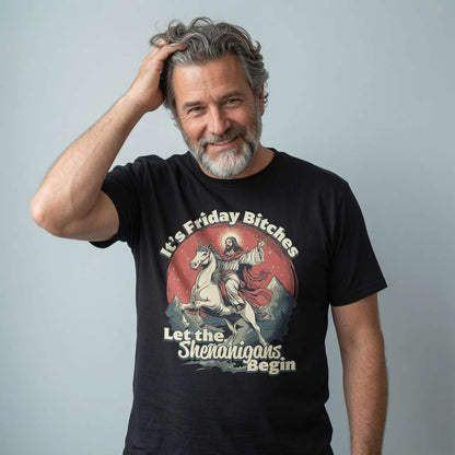 Grey-haired man smiling with hand in hair in black It’s Friday Bitches Let the Shenanigans Begin t-shirt, funny witty mens jesus
