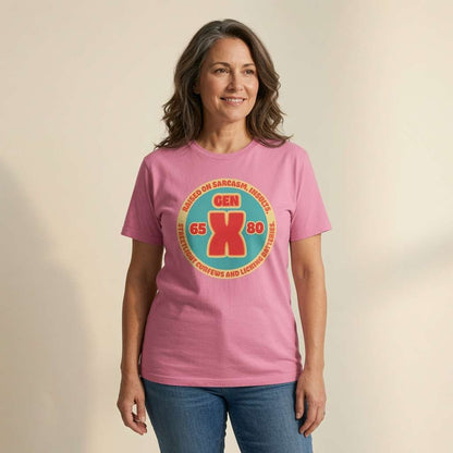 Grey-haired woman smiling in pink Gen X t-shirt with circular 65-80 design, ladies fun gen x slogan