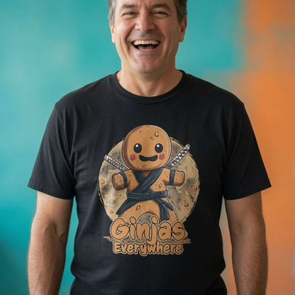 Man smiling while wearing a black Ginjas Everywhere t-shirt featuring a ninja gingerbread man with dual swords, funny mens ginger pun graphic design full of pure attitude