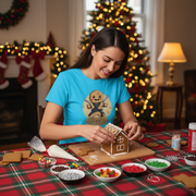 woman in a ginja ninja t-shirt building a gingerbread house