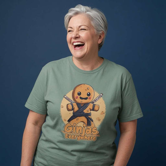 Woman laughing with both hands by her sides while wearing a green bay Ginjas Everywhere t-shirt featuring a ninja gingerbread man, funny ladies gingerbread graphic design full of pure attitude