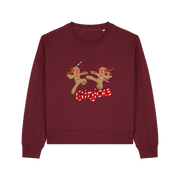 burgundy christmas sweater with the graphic of two gingerbread men fighting with candy canes and the slogan 'ginjas'