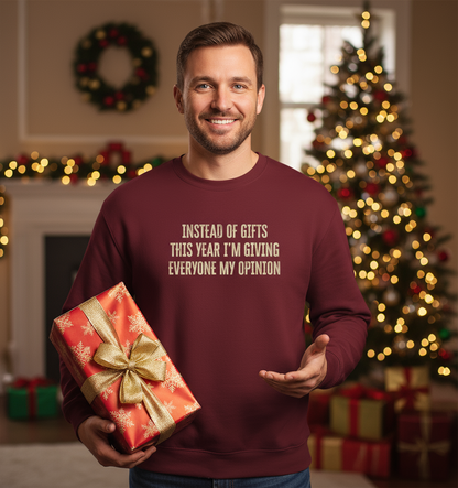 Man wearing a maroon sweatshirt with a humorous Christmas message, holding a gift in a decorated room.