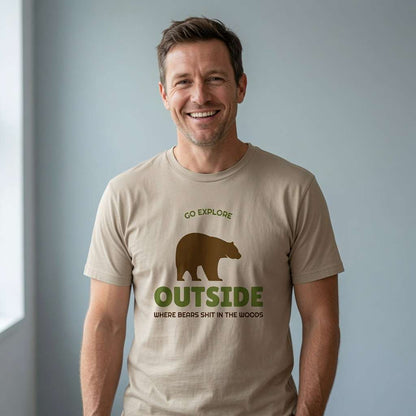 Man smiling in stone Go Explore Outside t-shirt featuring bear silhouette, funny mens rude camping bear graphic