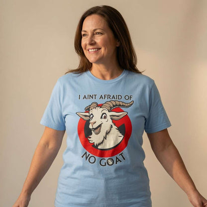 Woman smiling with arms slightly out in light blue I Ain’t Afraid of No Goat tee, funny ladies goat pun animal graphic
